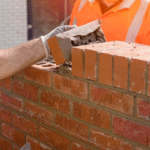 bricklayers-laying-bricks-on-mortar-600nw-2286434283